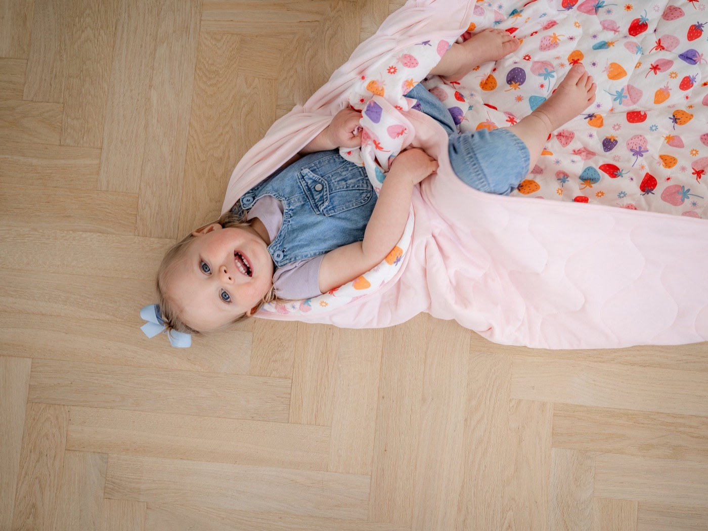 A baby lying on an Amor & Belief blanket